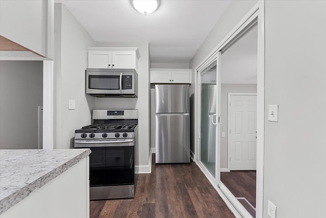 kitchen featuring white cabinetry, dark hardwood / wood-style flooring, and stainless steel appliances