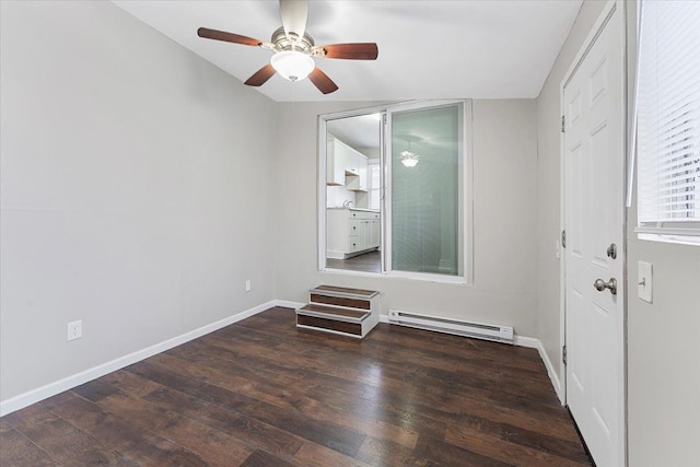 spare room featuring vaulted ceiling, a baseboard radiator, and dark hardwood / wood-style floors