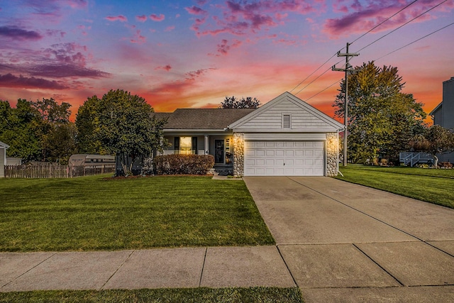 view of front of property featuring a lawn and a garage