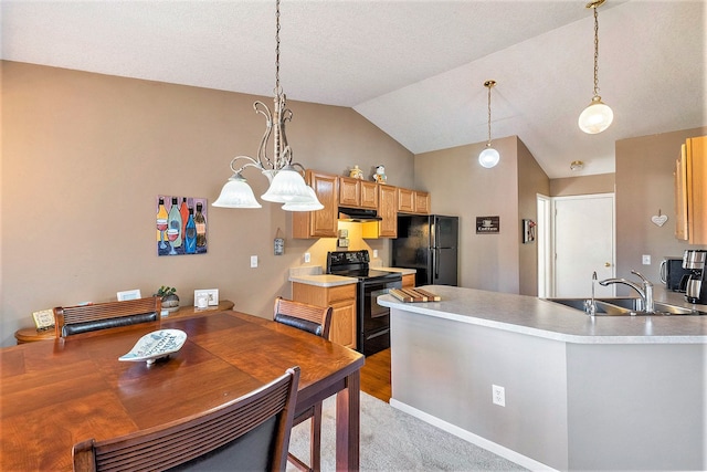 kitchen with pendant lighting, lofted ceiling, black appliances, sink, and kitchen peninsula