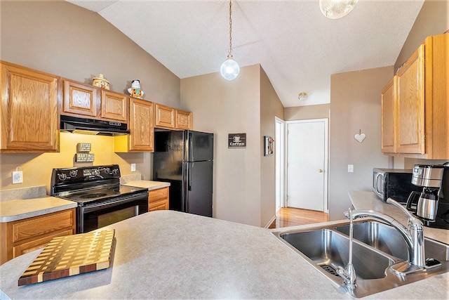 kitchen with black appliances, decorative light fixtures, lofted ceiling, and sink