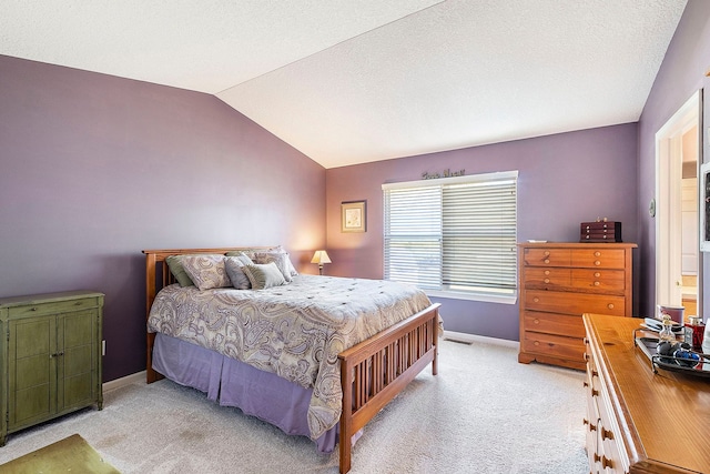 carpeted bedroom with vaulted ceiling