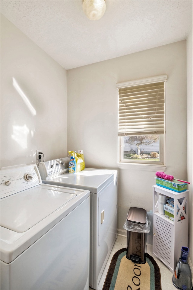 laundry area featuring washer and clothes dryer and a textured ceiling