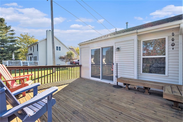 wooden deck with a lawn