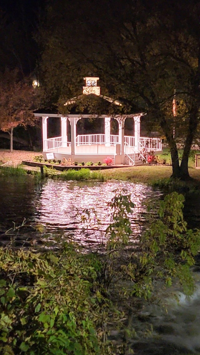 surrounding community with a deck with water view