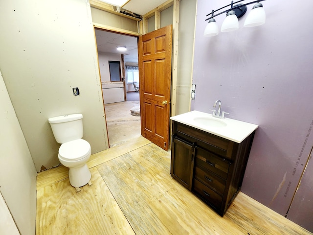 13910 M 40th Hwy, Gobles, MI 49055 - bathroom with vanity, hardwood / wood-style flooring, and toilet