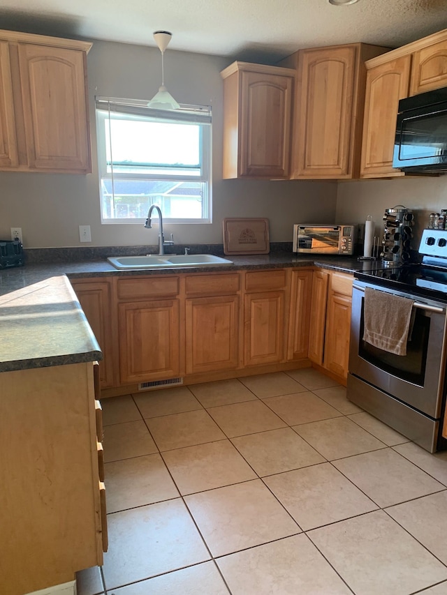 kitchen featuring stainless steel electric range oven, sink, and light tile patterned floors