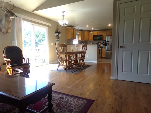 dining space with a chandelier and light wood-type flooring