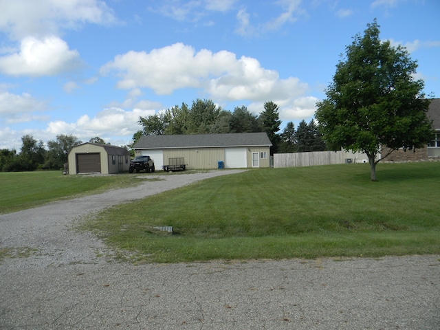 view of front of home with an outbuilding, a garage, and a front lawn