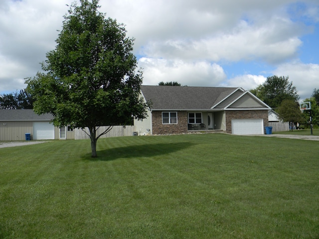 view of front of property with a garage and a front lawn