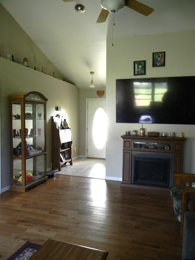 living room featuring ceiling fan, hardwood / wood-style floors, and high vaulted ceiling