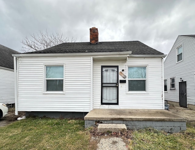 rear view of property with a yard