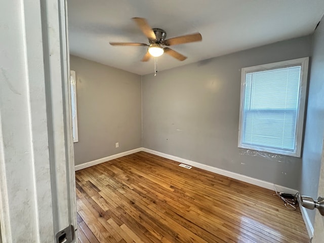 spare room featuring hardwood / wood-style flooring and ceiling fan