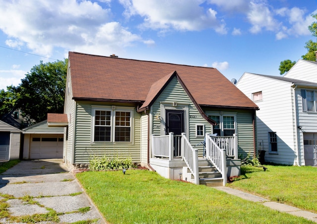 view of front of home featuring a garage, an outdoor structure, and a front yard