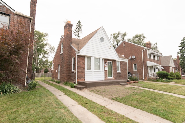 bungalow-style home featuring a front lawn