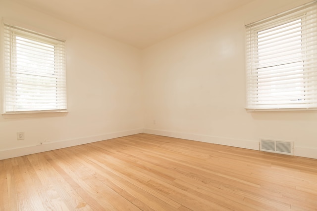 empty room with light hardwood / wood-style flooring