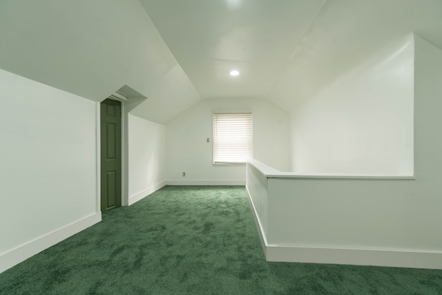 bonus room featuring dark carpet and lofted ceiling