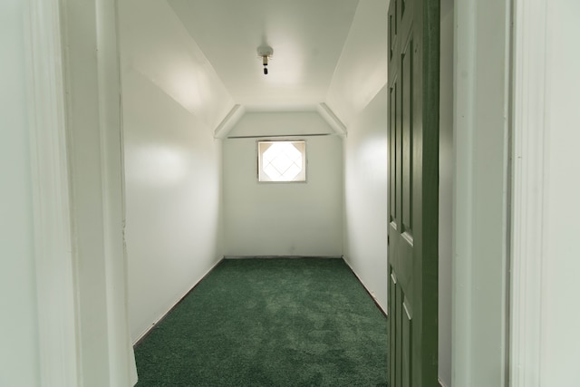 additional living space with lofted ceiling and dark colored carpet