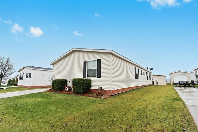 view of home's exterior with a yard, a garage, and an outdoor structure