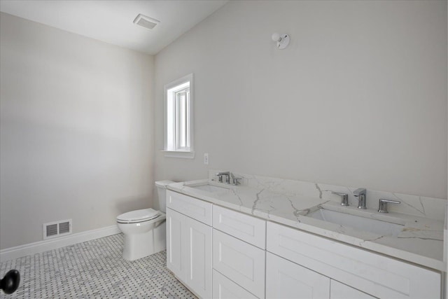 bathroom featuring baseboards, visible vents, a sink, and toilet