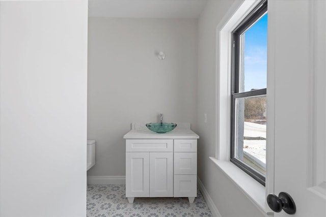 bathroom with vanity and baseboards