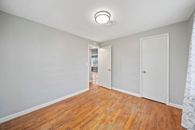 unfurnished bedroom with light wood-type flooring