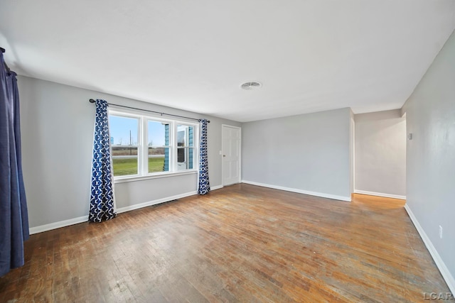 empty room with hardwood / wood-style flooring