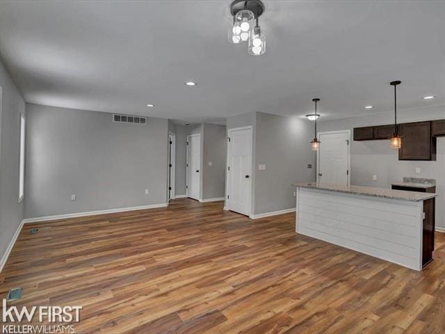 unfurnished living room featuring hardwood / wood-style flooring