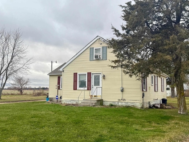 rear view of house featuring a lawn