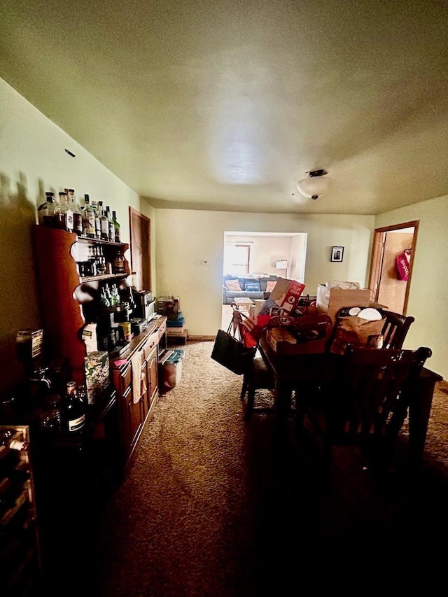 dining room with carpet, bar area, and a textured ceiling