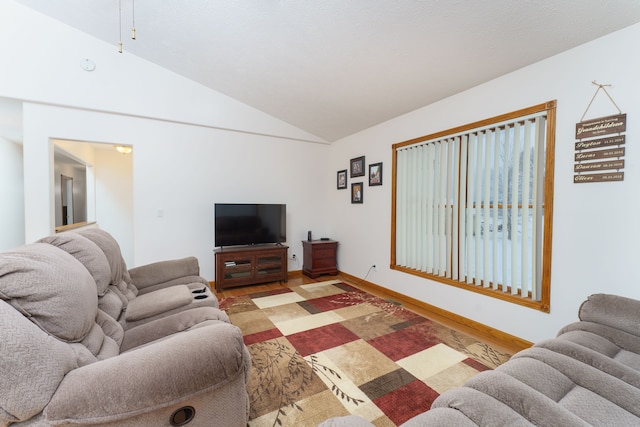 living room featuring wood-type flooring and vaulted ceiling