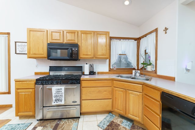 kitchen with sink, lofted ceiling, light tile patterned flooring, tasteful backsplash, and black appliances