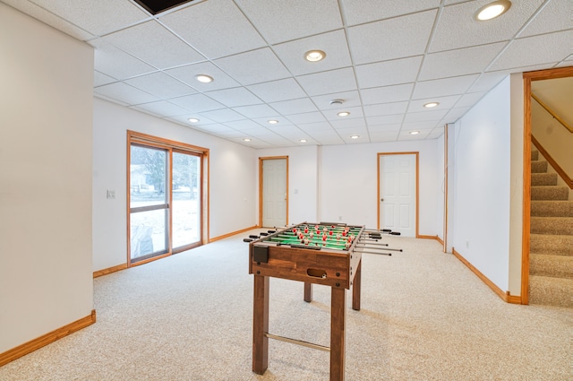 recreation room featuring a paneled ceiling and carpet