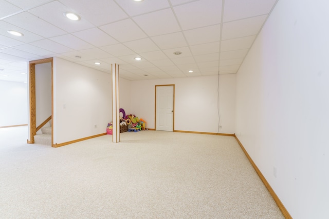 playroom with a paneled ceiling and carpet