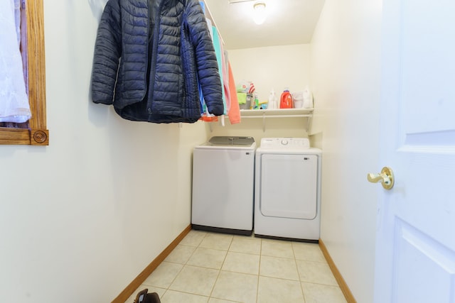 laundry area with separate washer and dryer and light tile patterned floors