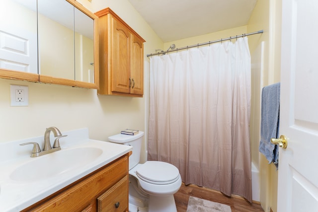 full bathroom with toilet, shower / tub combo, vanity, and hardwood / wood-style floors