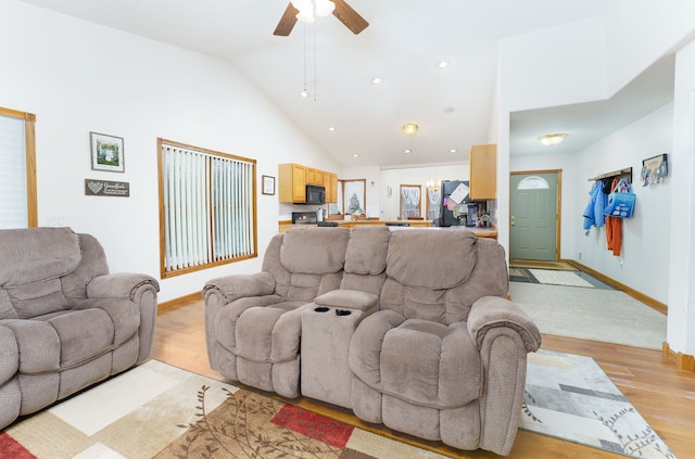 living room with high vaulted ceiling, ceiling fan, and light hardwood / wood-style floors