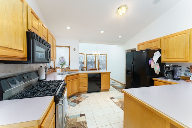 kitchen featuring black appliances, light tile patterned floors, a notable chandelier, sink, and lofted ceiling