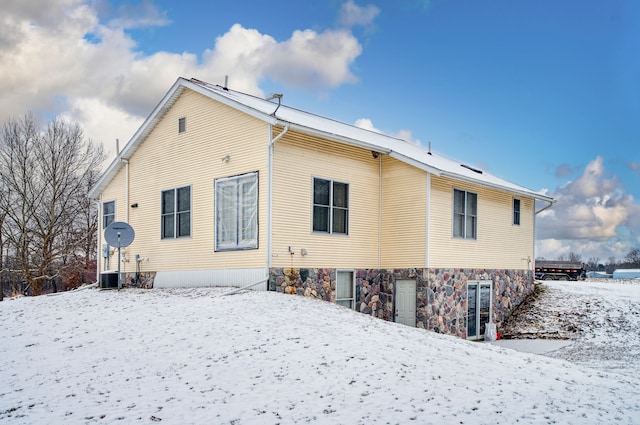 view of snow covered back of property