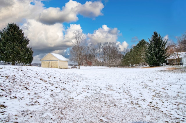 snowy yard featuring an outdoor structure