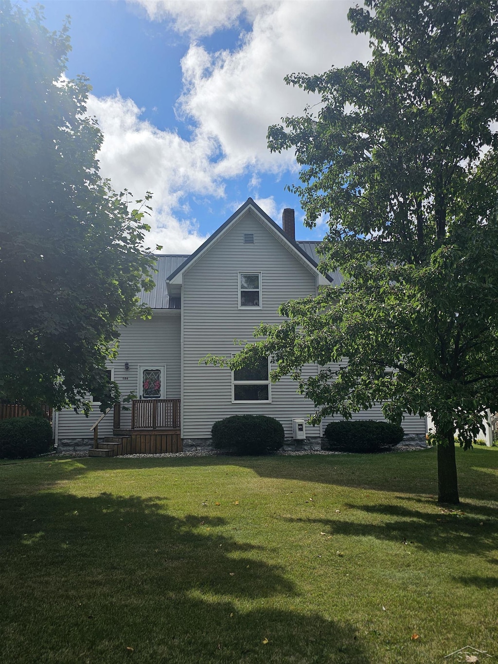 view of side of home featuring a yard