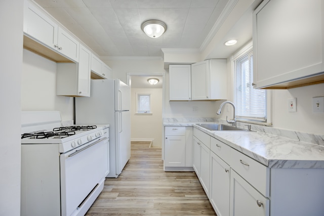 kitchen featuring white cabinets, crown molding, sink, and white range with gas cooktop