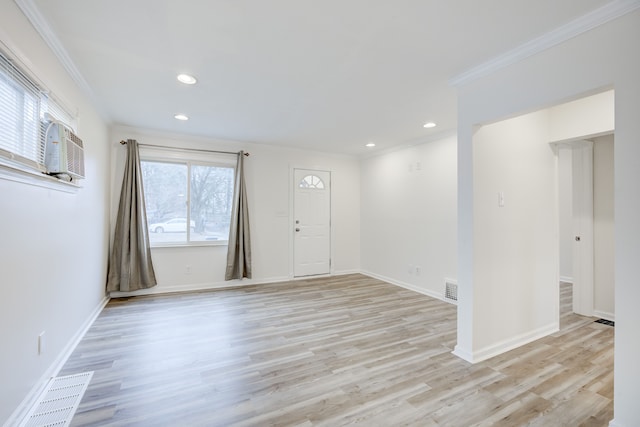 entrance foyer featuring crown molding and light wood-type flooring