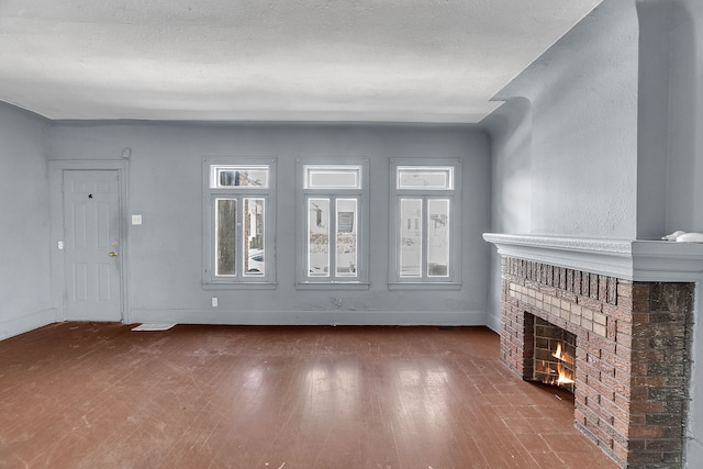 unfurnished living room with a fireplace and hardwood / wood-style flooring