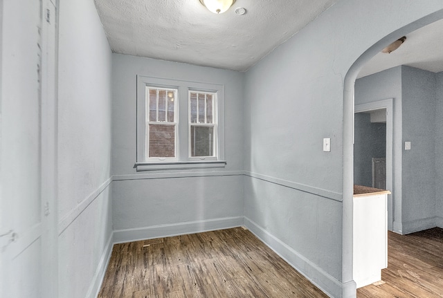 empty room featuring hardwood / wood-style floors and a textured ceiling