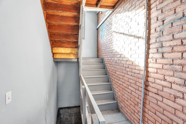 stairs featuring brick wall