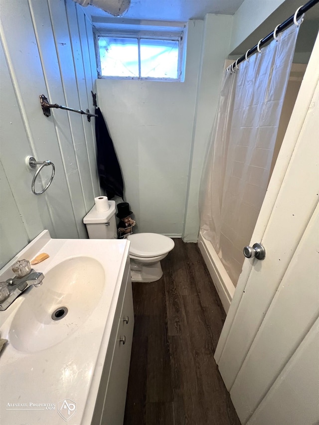 bathroom with vanity, hardwood / wood-style flooring, curtained shower, and toilet