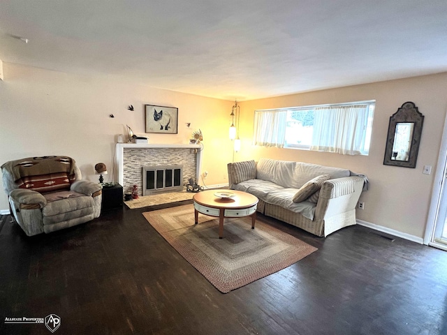 living room featuring dark hardwood / wood-style flooring and a fireplace