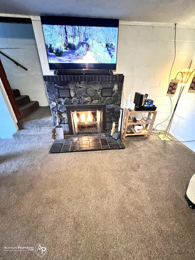 interior details with carpet flooring, a fireplace, and a textured ceiling