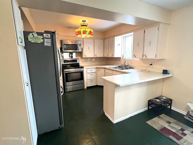 kitchen featuring white cabinetry, appliances with stainless steel finishes, sink, and kitchen peninsula